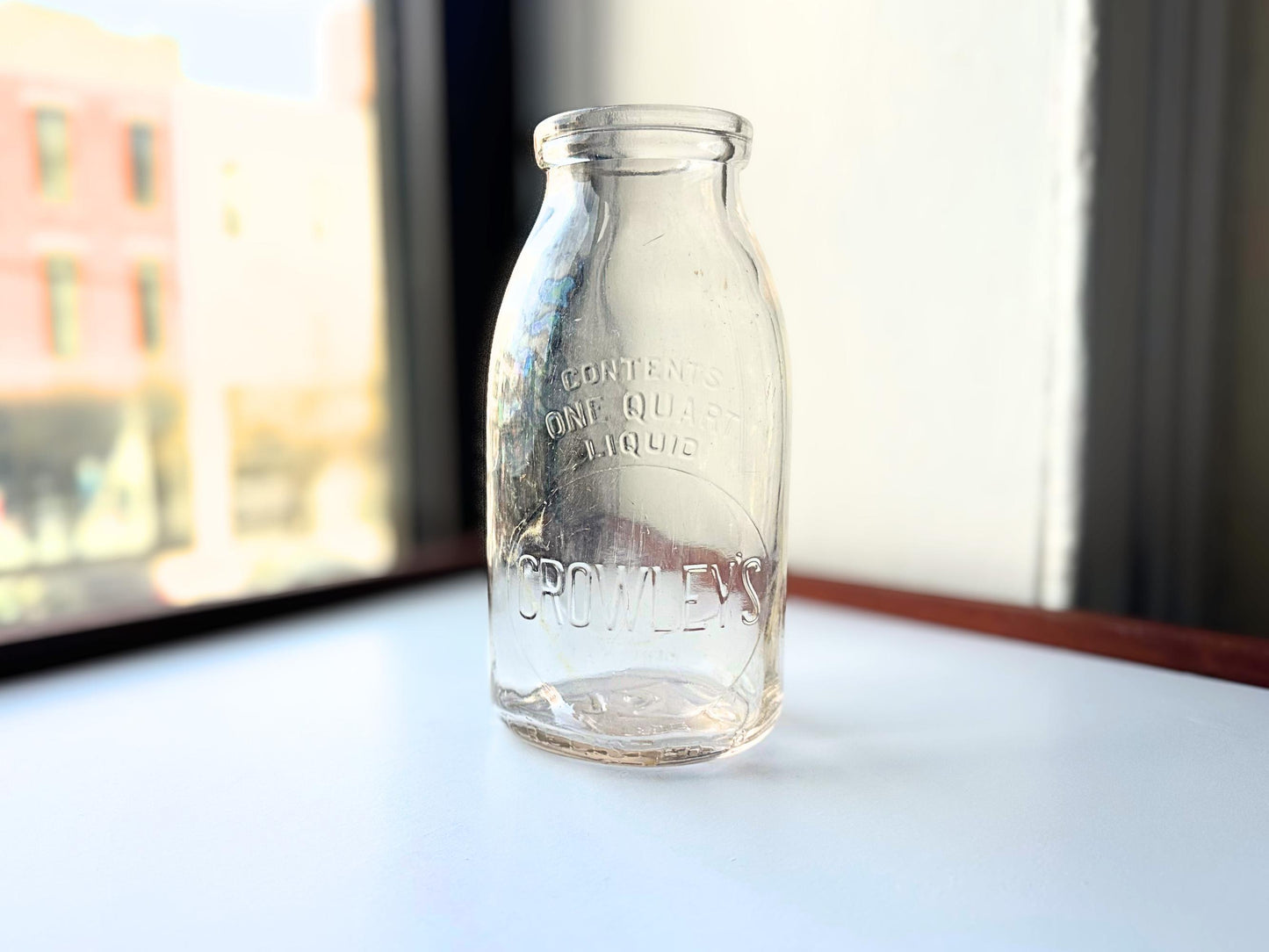 Vintage Crowley's one quart milk bottle with pink tinted glass and embossed Fine Quality lettering. Perfect for farmhouse cottagecore vintage kitchen decor, single stem vase, flower display, or dairy bottle collection. Rescued from NYC beaches.