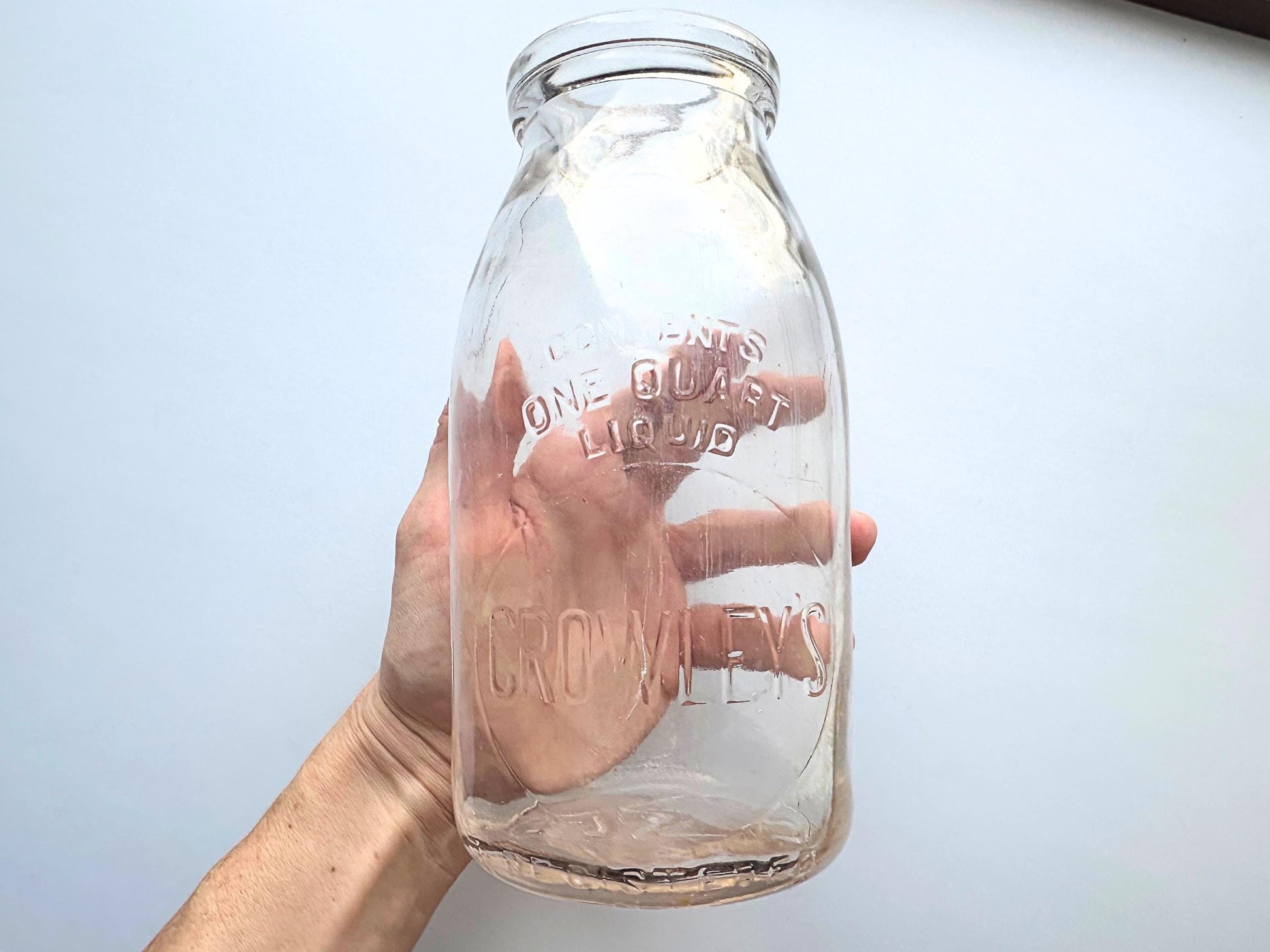 Vintage Crowley's one quart milk bottle with pink tinted glass and embossed Fine Quality lettering. Perfect for farmhouse cottagecore vintage kitchen decor, single stem vase, flower display, or dairy bottle collection. Rescued from NYC beaches.