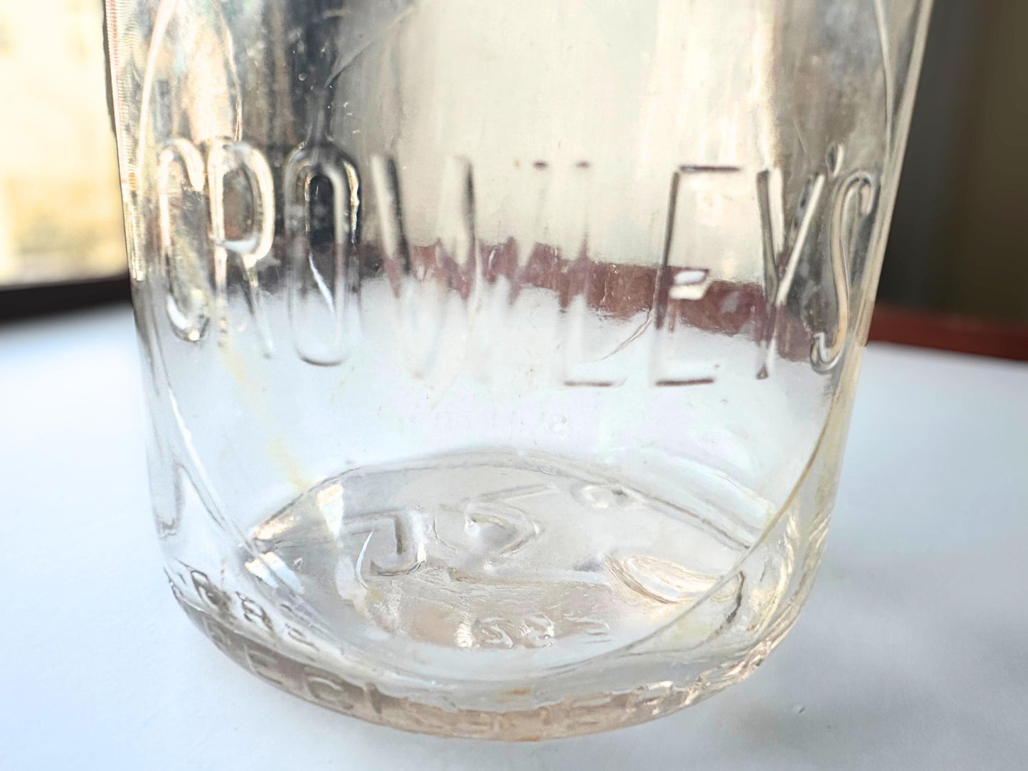 Vintage Crowley's one quart milk bottle with pink tinted glass and embossed Fine Quality lettering. Perfect for farmhouse cottagecore vintage kitchen decor, single stem vase, flower display, or dairy bottle collection. Rescued from NYC beaches.