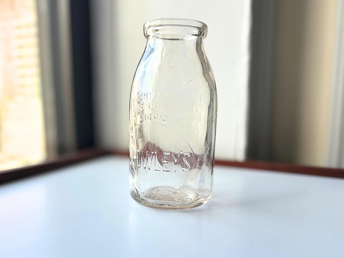 Vintage Crowley's one quart milk bottle with pink tinted glass and embossed Fine Quality lettering. Perfect for farmhouse cottagecore vintage kitchen decor, single stem vase, flower display, or dairy bottle collection. Rescued from NYC beaches.