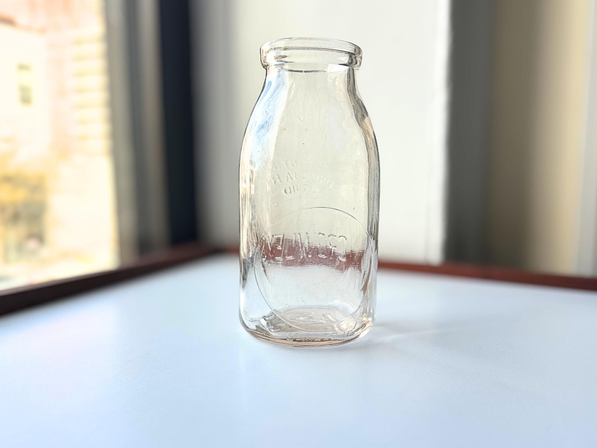 Vintage Crowley's one quart milk bottle with pink tinted glass and embossed Fine Quality lettering. Perfect for farmhouse cottagecore vintage kitchen decor, single stem vase, flower display, or dairy bottle collection. Rescued from NYC beaches.