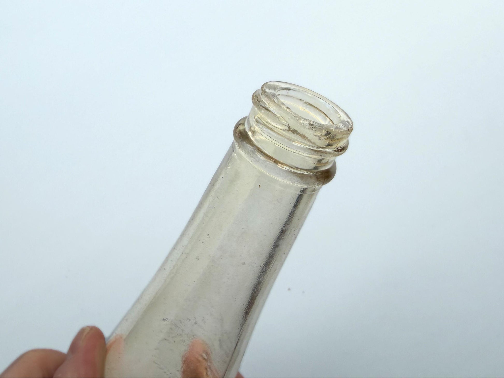 Vintage Garrett and Co Virginia Dare clear glass wine bottle 8.75 inches tall with full-body embossed crest and pre-Prohibition text - hand-recovered from NYC dumping grounds