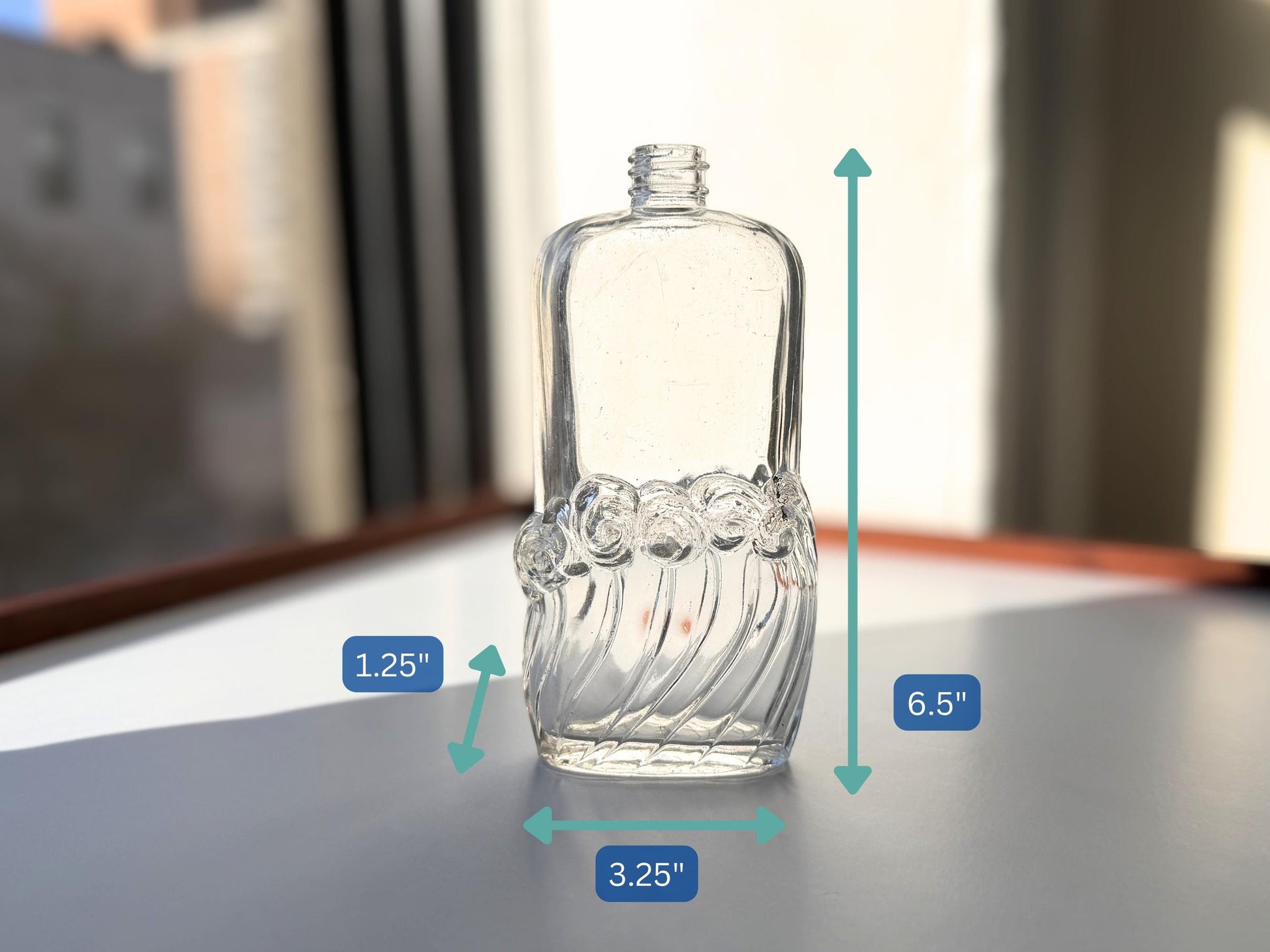 Vintage glass waves textured bottle with distinctive wavy pattern throughout. Clear glass with light patina. Perfect for vintage glass collectors and pattern enthusiasts.