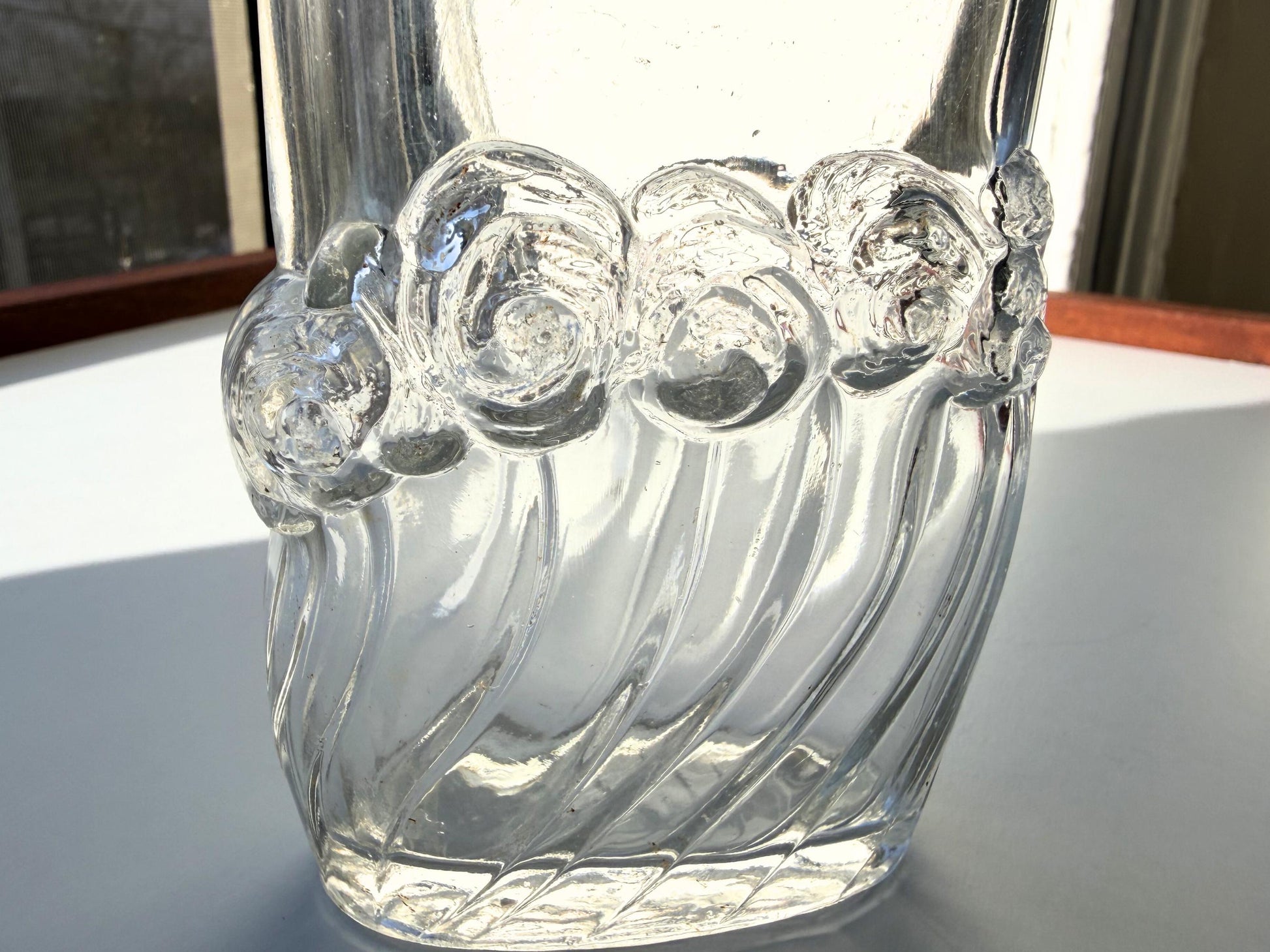 Vintage glass waves textured bottle with distinctive wavy pattern throughout. Clear glass with light patina. Perfect for vintage glass collectors and pattern enthusiasts.