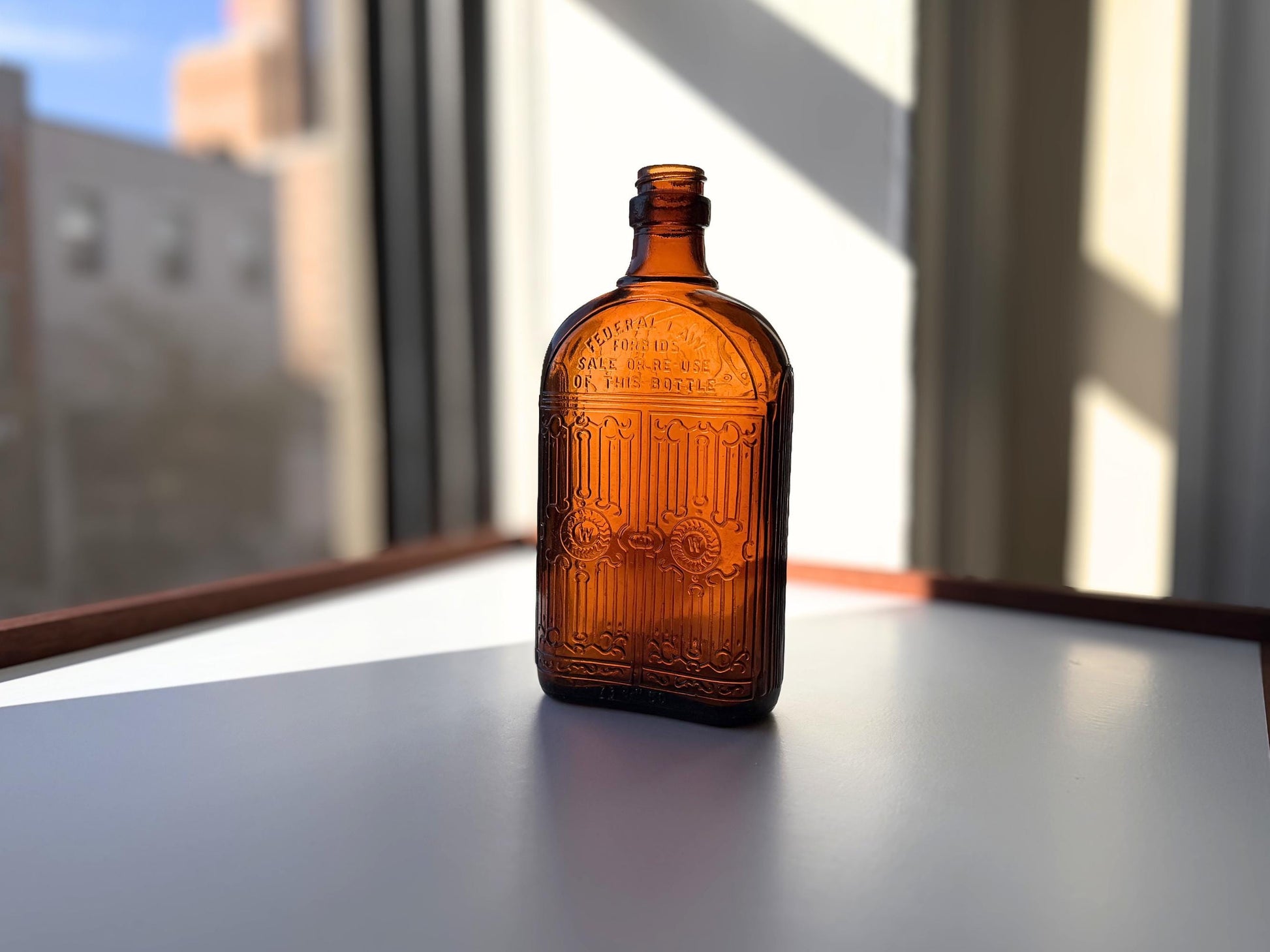 Vintage Hiram Walker amber flask with bottled by Hiram Walker marking. Good condition showing authentic wear. Perfect for spirits collectors and vintage bar displays.