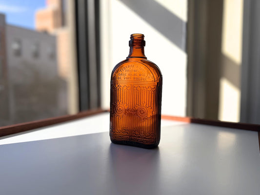 Vintage Hiram Walker amber flask with bottled by Hiram Walker marking. Good condition showing authentic wear. Perfect for spirits collectors and vintage bar displays.