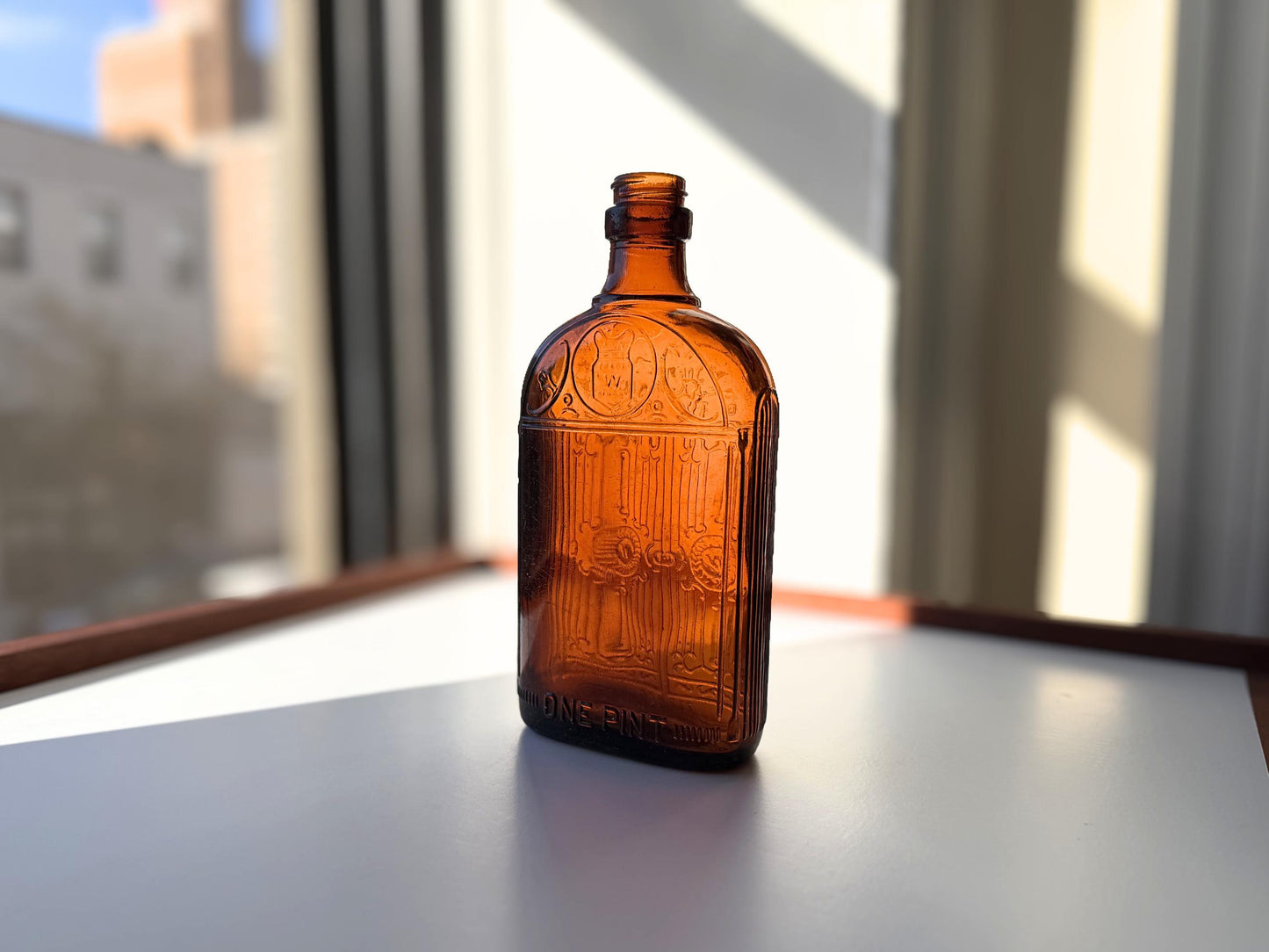 Vintage Hiram Walker amber flask with bottled by Hiram Walker marking. Good condition showing authentic wear. Perfect for spirits collectors and vintage bar displays.