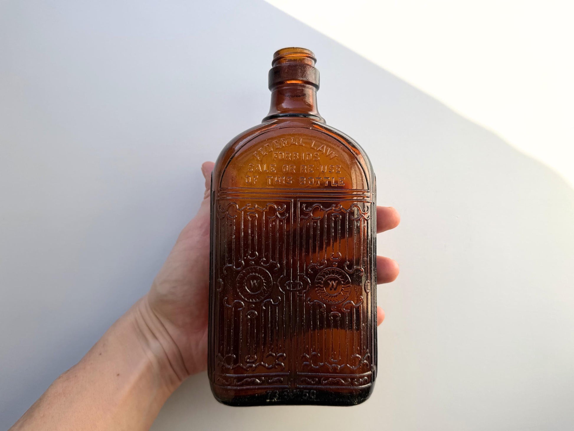 Vintage Hiram Walker amber flask with bottled by Hiram Walker marking. Good condition showing authentic wear. Perfect for spirits collectors and vintage bar displays.