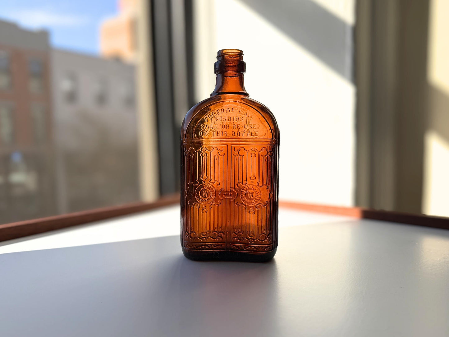 Vintage Hiram Walker amber flask with bottled by Hiram Walker marking. Good condition showing authentic wear. Perfect for spirits collectors and vintage bar displays.