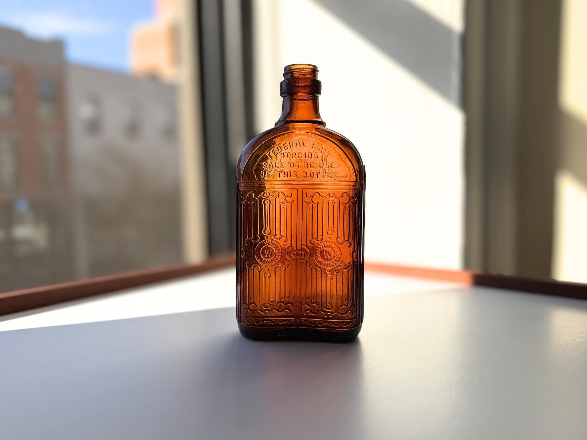 Vintage Hiram Walker amber flask with bottled by Hiram Walker marking. Good condition showing authentic wear. Perfect for spirits collectors and vintage bar displays.