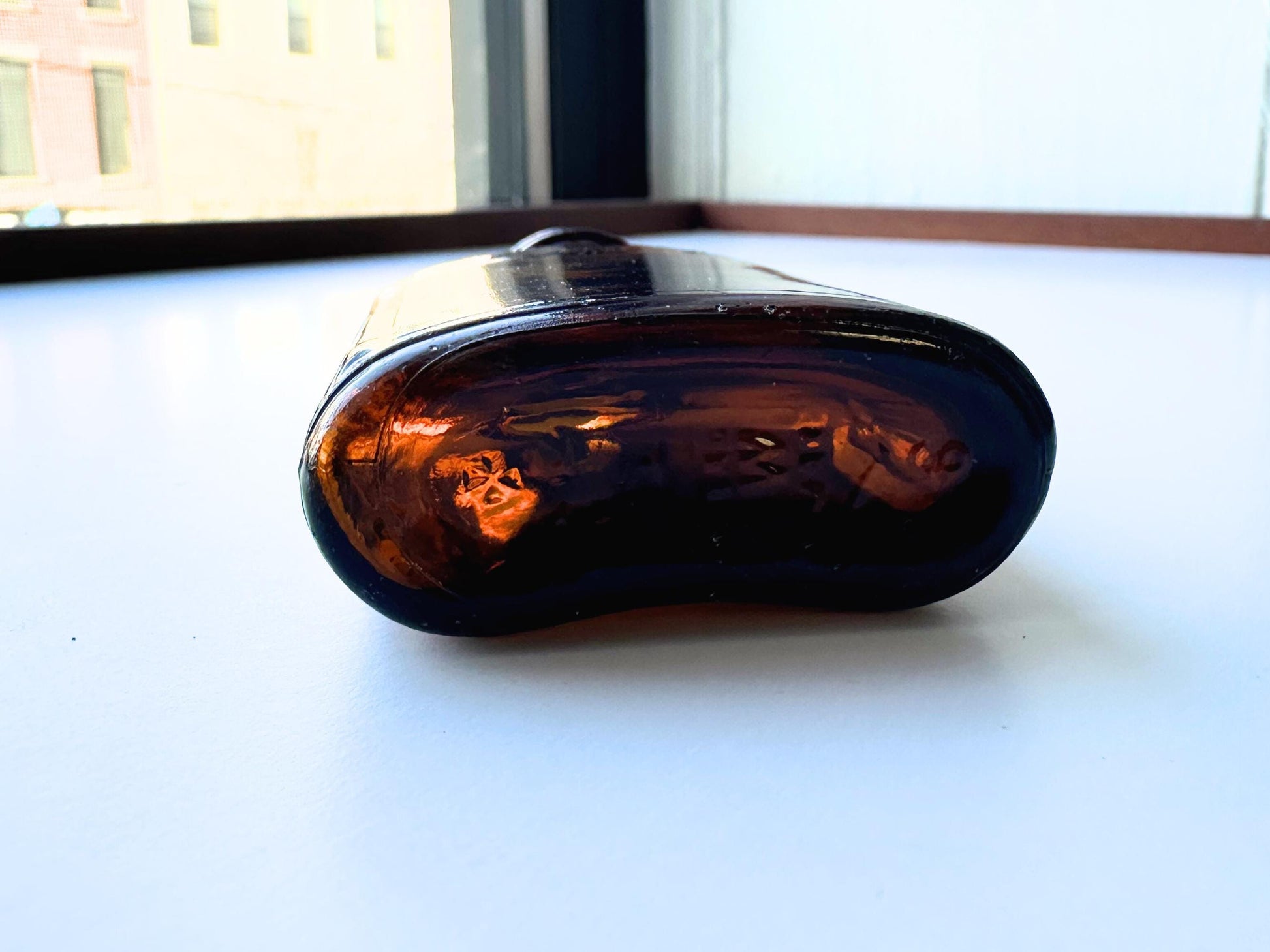 Vintage Hiram Walker small amber bottle with embossed "W" logo on bottom. Perfect for spirits collectors, bar displays, and vintage amber glass enthusiasts. Good condition warm amber glass bottle with minor nicks showing authentic vintage w