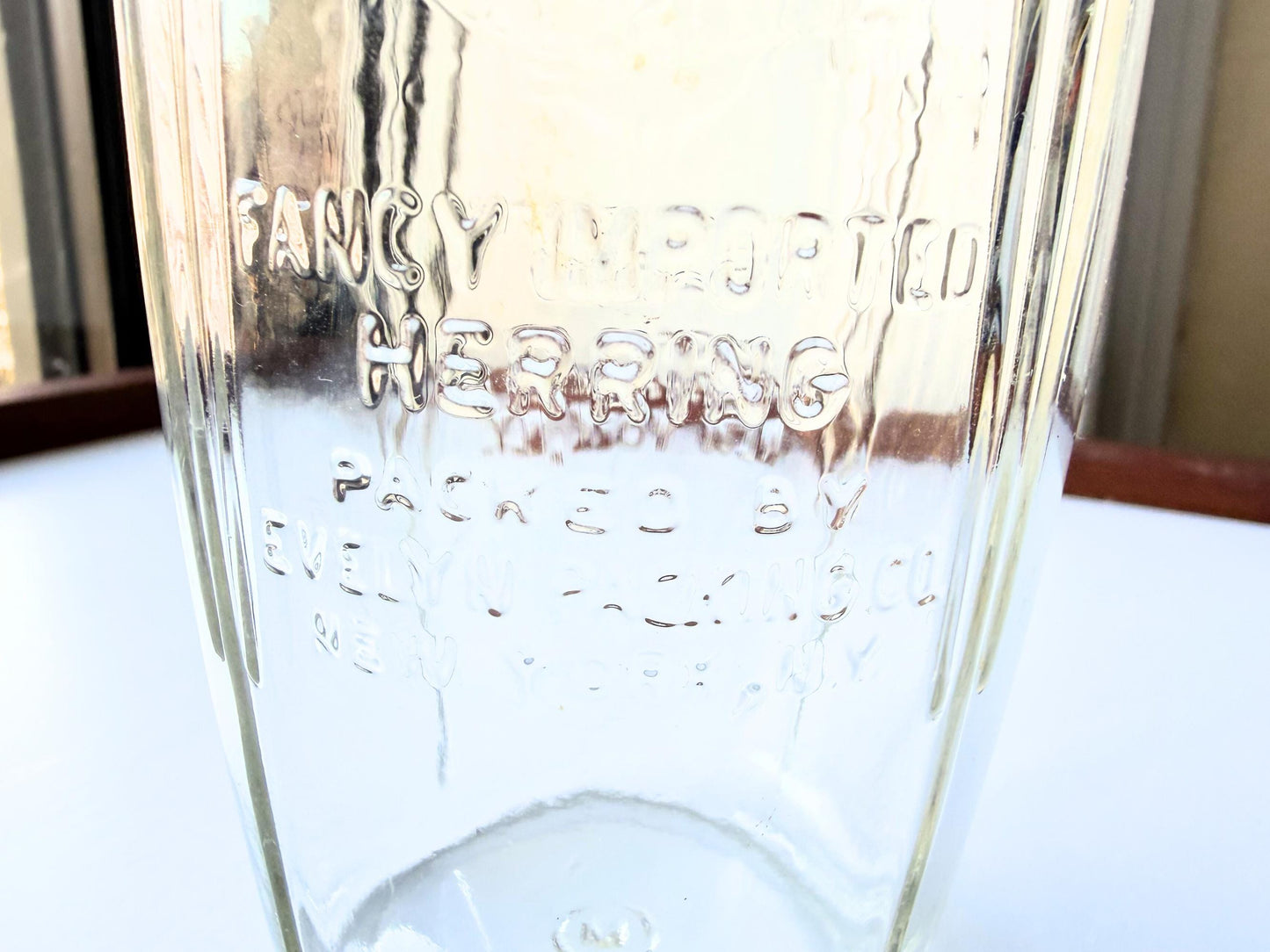 Vintage 1920s-1940s Kingfish Brand clear glass herring jar with bold embossed lettering from Evelyn Packing Company in New York. Perfect for windowsill displays, vintage kitchen collections, and farmhouse or cottagecore decor.