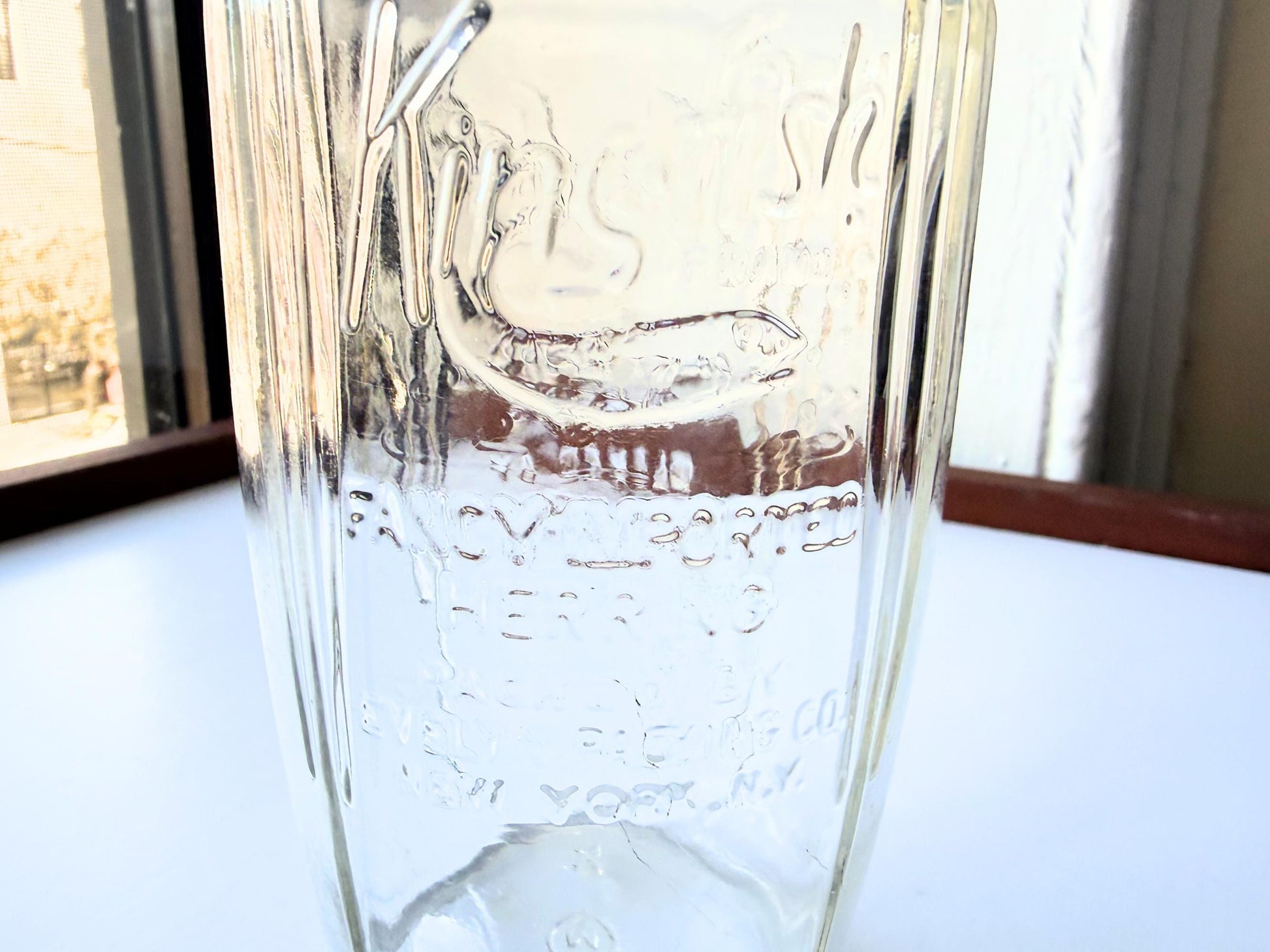 Vintage 1920s-1940s Kingfish Brand clear glass herring jar with bold embossed lettering from Evelyn Packing Company in New York. Perfect for windowsill displays, vintage kitchen collections, and farmhouse or cottagecore decor.