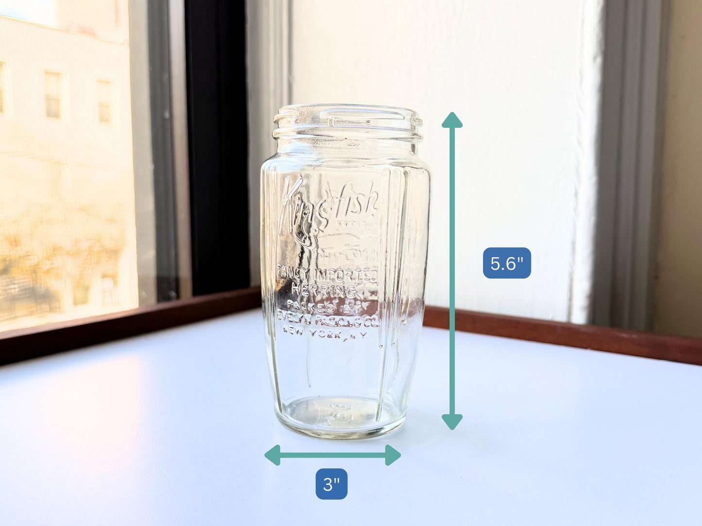 Vintage 1920s-1940s Kingfish Brand clear glass herring jar with bold embossed lettering from Evelyn Packing Company in New York. Perfect for windowsill displays, vintage kitchen collections, and farmhouse or cottagecore decor.