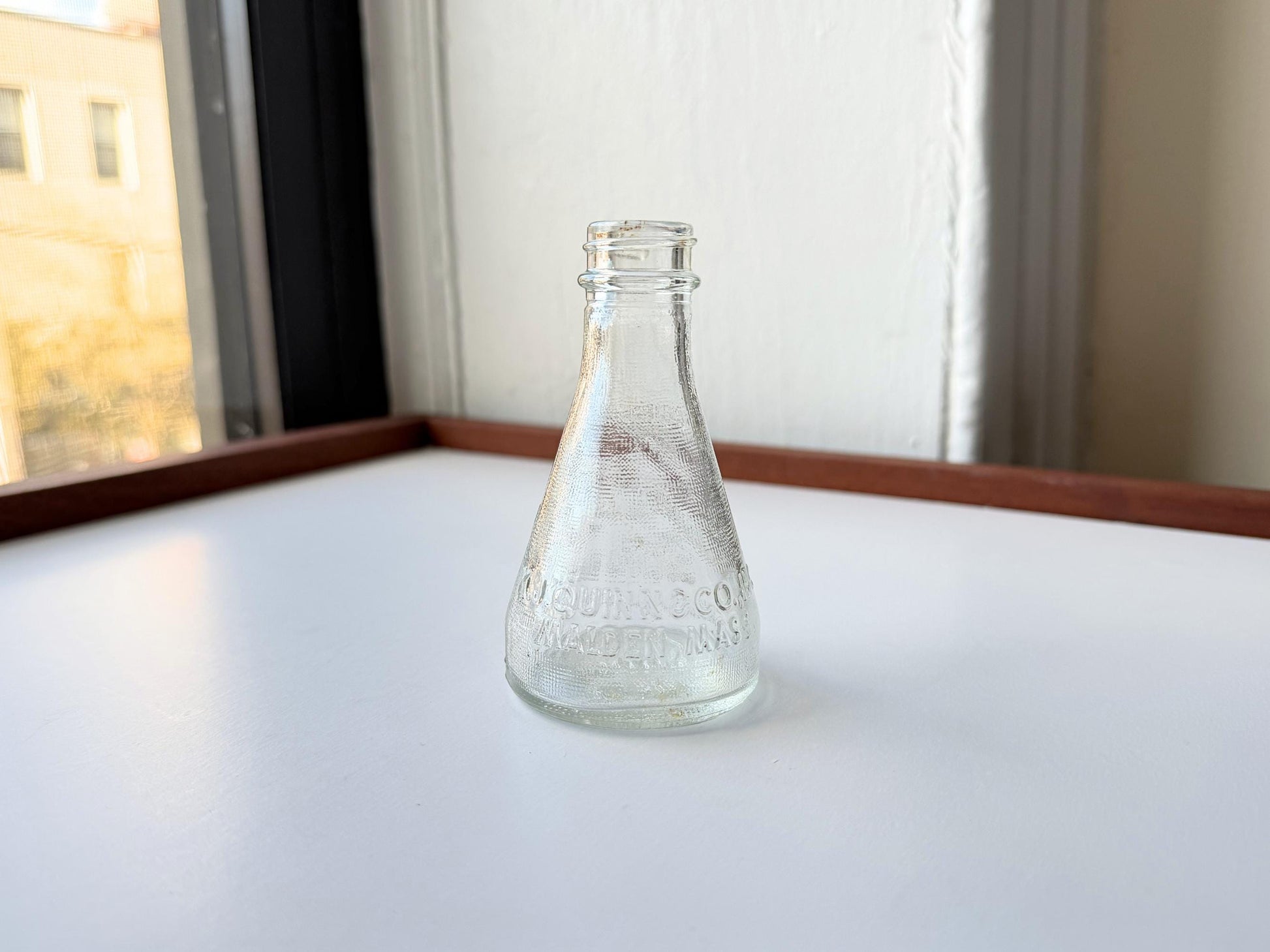 Vintage 1940s-1960s Quintone Scuffy shoe polish bottle with embossed lettering from KJ Quinn and Co Inc Malden Massachusetts. Perfect for vintage product collectors, bathroom displays, and cottagecore decor.