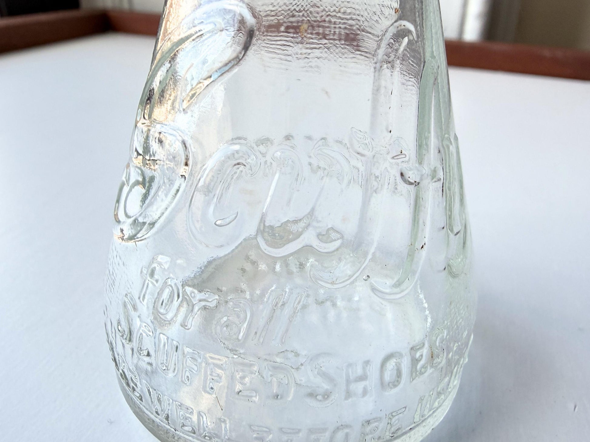 Vintage 1940s-1960s Quintone Scuffy shoe polish bottle with embossed lettering from KJ Quinn and Co Inc Malden Massachusetts. Perfect for vintage product collectors, bathroom displays, and cottagecore decor.