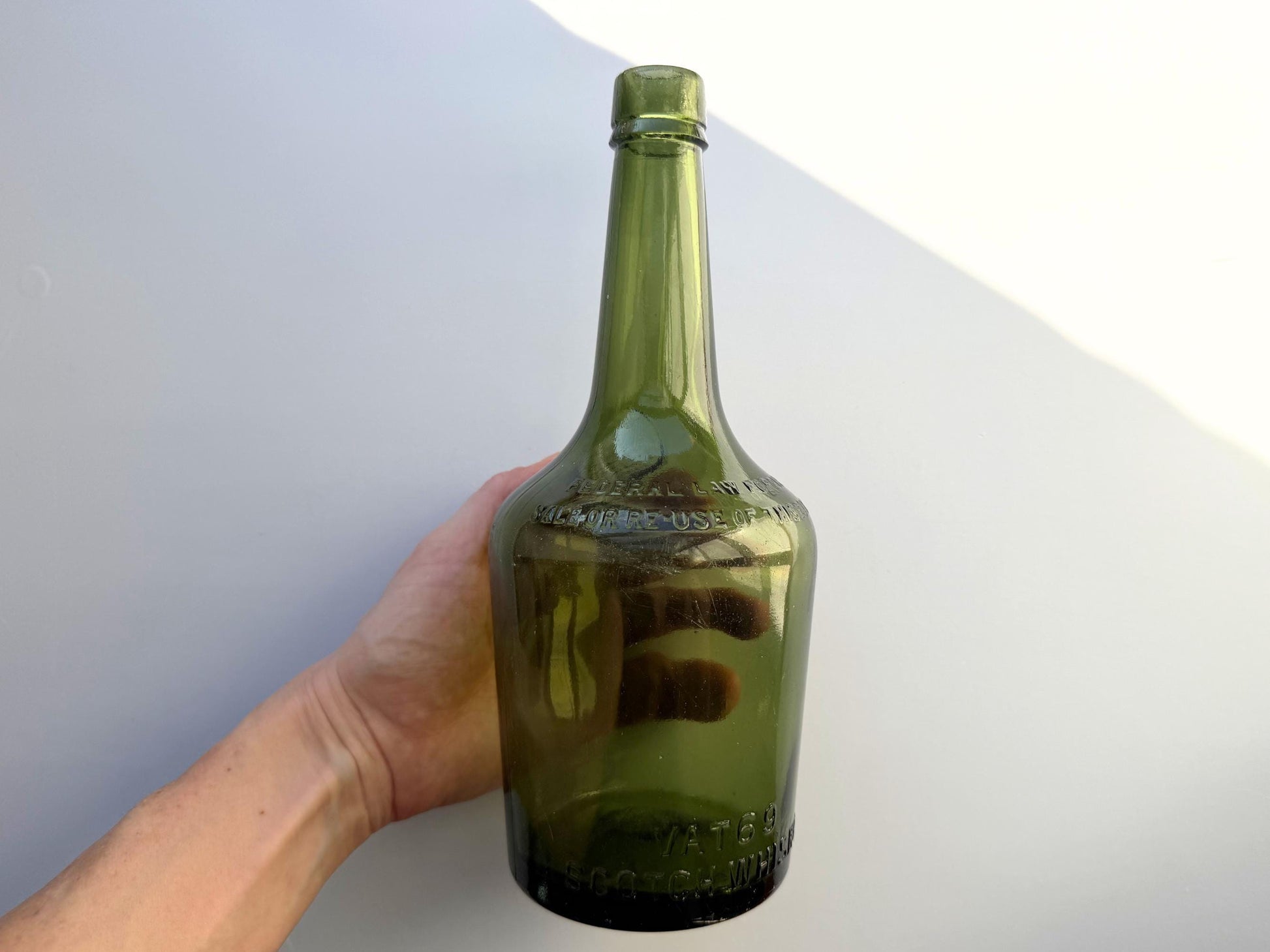 Vintage VAT69 Scotch whisky bottle with embossed lettering and Federal Law marking. Perfect for whisky collectors and Scottish spirits enthusiasts – Brooklyn Sea Glass