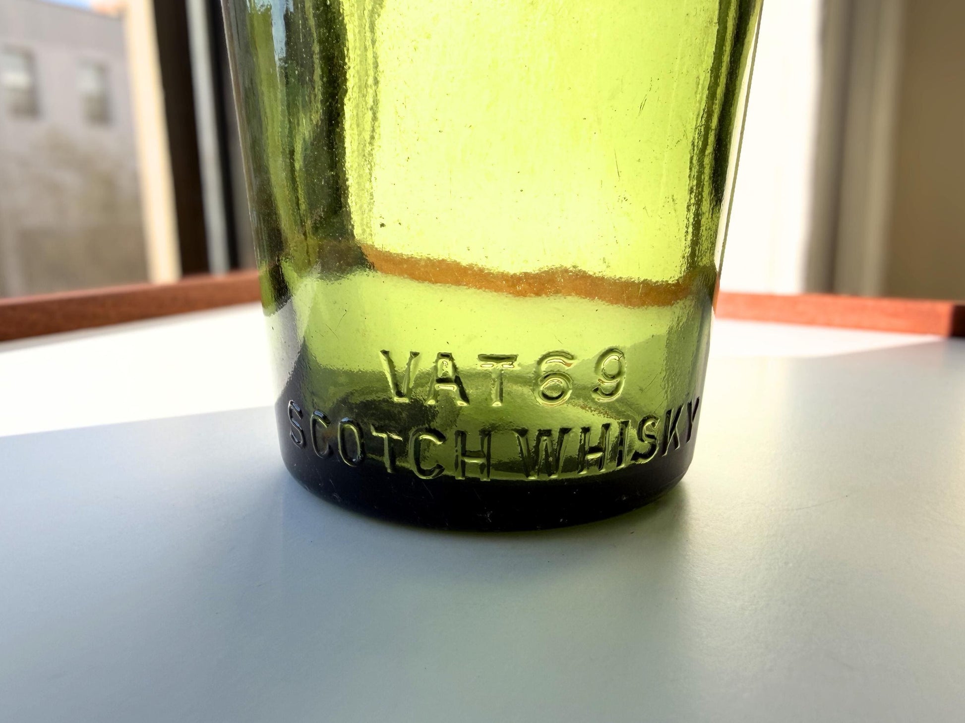Vintage VAT69 Scotch whisky bottle with embossed lettering and Federal Law marking. Perfect for whisky collectors and Scottish spirits enthusiasts – Brooklyn Sea Glass