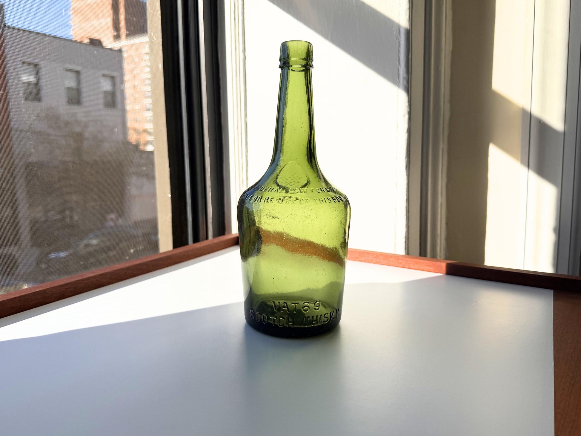 Vintage VAT69 Scotch whisky bottle with embossed lettering and Federal Law marking. Perfect for whisky collectors and Scottish spirits enthusiasts – Brooklyn Sea Glass