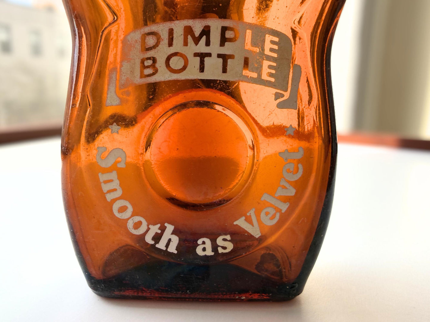 Vintage Velvet Edge amber dimple bottle 7 inches tall dated 1952 with figure-8 silhouette and Federal Law embossing - hand-recovered from NYC mid-century dumping grounds