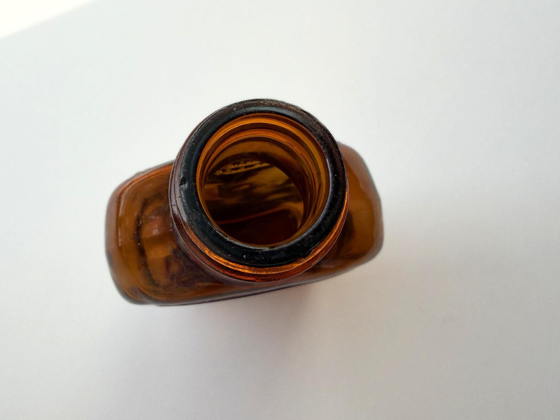 Vintage Velvet Edge amber dimple bottle 7 inches tall dated 1952 with figure-8 silhouette and Federal Law embossing - hand-recovered from NYC mid-century dumping grounds