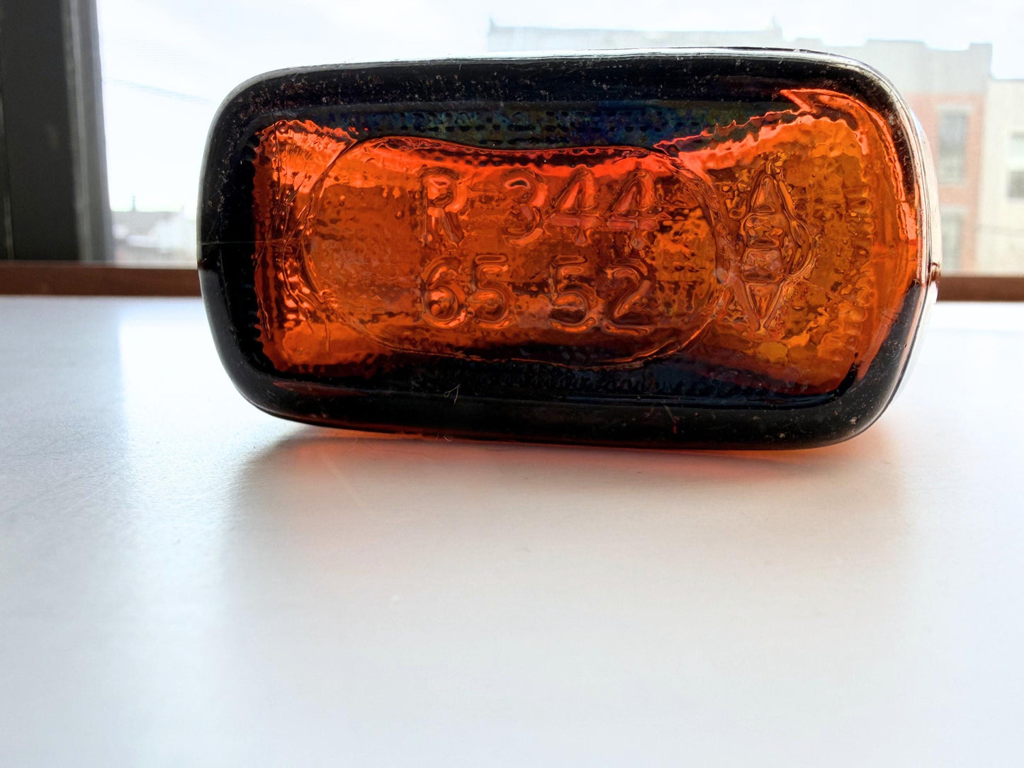 Vintage Velvet Edge amber dimple bottle 7 inches tall dated 1952 with figure-8 silhouette and Federal Law embossing - hand-recovered from NYC mid-century dumping grounds