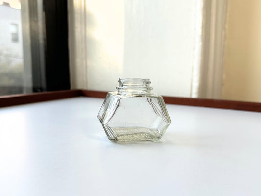 Vintage Waterman's 2oz ink bottle with hexagonal shape and patent marking. Perfect for vintage stationery collectors, office displays, and writing enthusiasts.