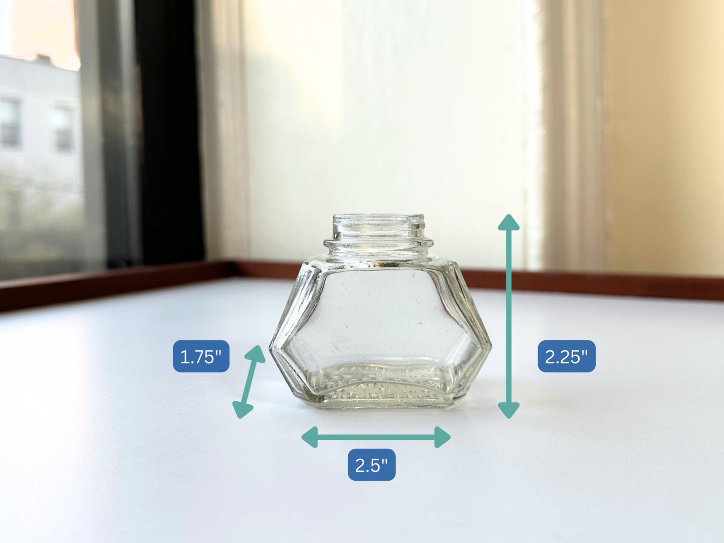 Vintage Waterman's 2oz ink bottle with hexagonal shape and patent marking. Perfect for vintage stationery collectors, office displays, and writing enthusiasts.