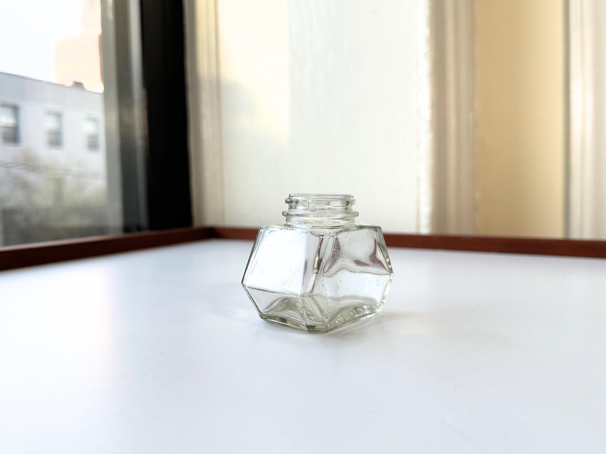 Vintage Waterman's 2oz ink bottle with hexagonal shape and patent marking. Perfect for vintage stationery collectors, office displays, and writing enthusiasts.