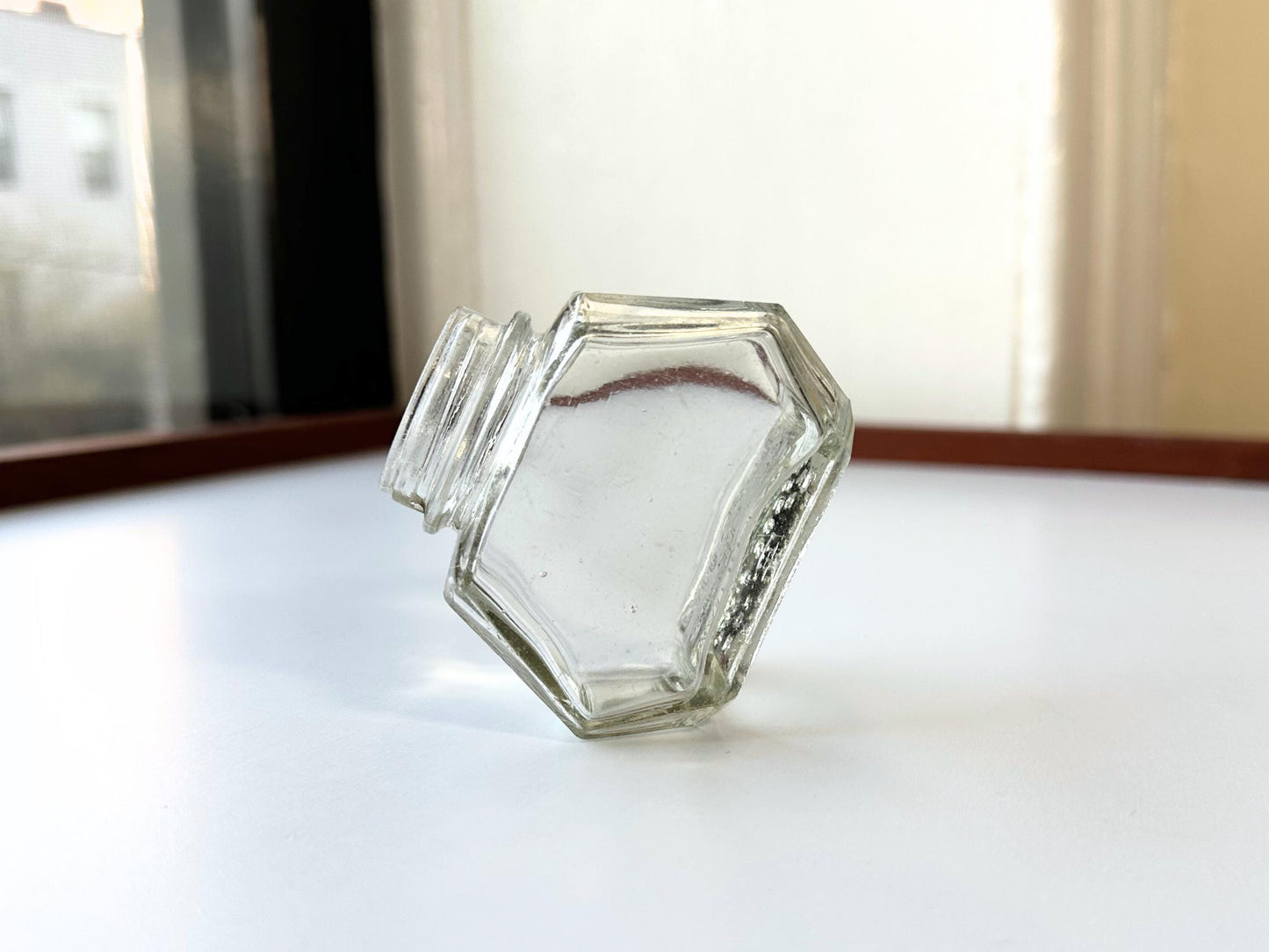 Vintage Waterman's 2oz ink bottle with hexagonal shape and patent marking. Perfect for vintage stationery collectors, office displays, and writing enthusiasts.