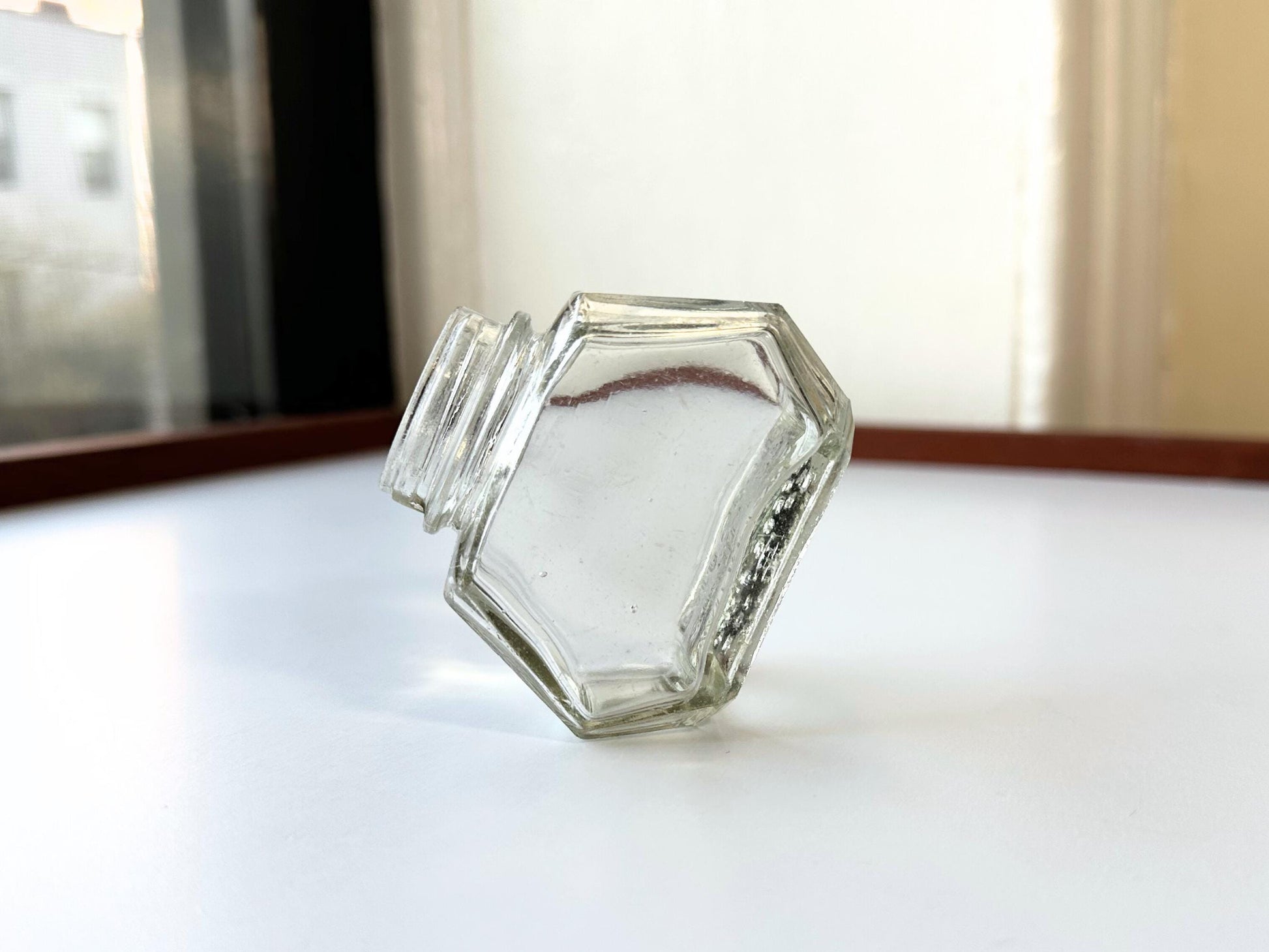Vintage Waterman's 2oz ink bottle with hexagonal shape and patent marking. Perfect for vintage stationery collectors, office displays, and writing enthusiasts.