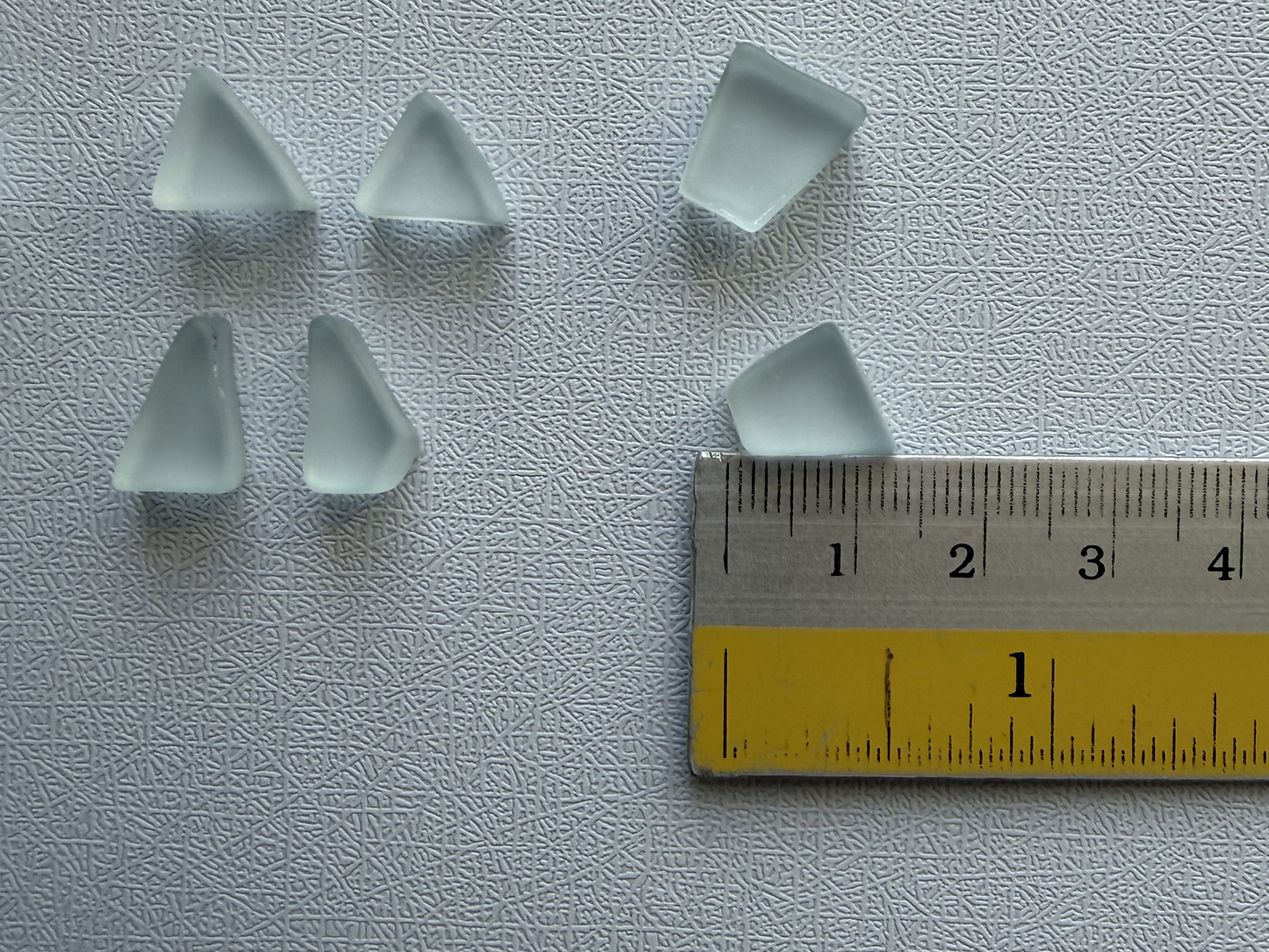 Ice blue glass pairs next to ruler showing 10–15mm size, ideal for wire wrap earrings