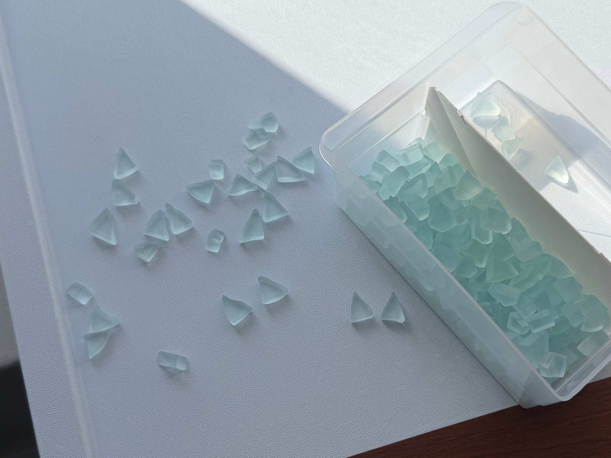 Ice blue tumbled glass pairs in storage container showing quantity — 5 pairs per set