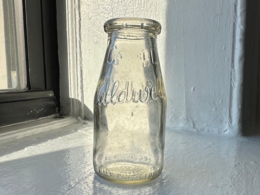 Caldwell Dairy milk bottle full front view, clear glass half-pint with CALDWELL and C STORE embossing, Brooklyn NY, NYC recovery