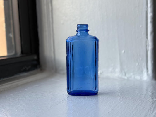 Cobalt blue Art Deco medicine bottle full front view, rectangular glass, NYC beach recovery