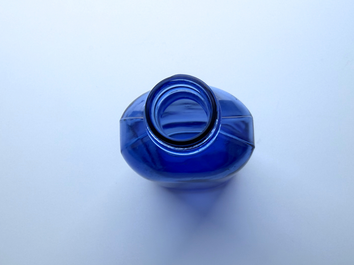 Phillips cobalt blue bottle top-down view into open mouth