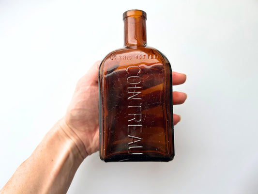 Cointreau bottle angled view showing amber glass and square silhouette