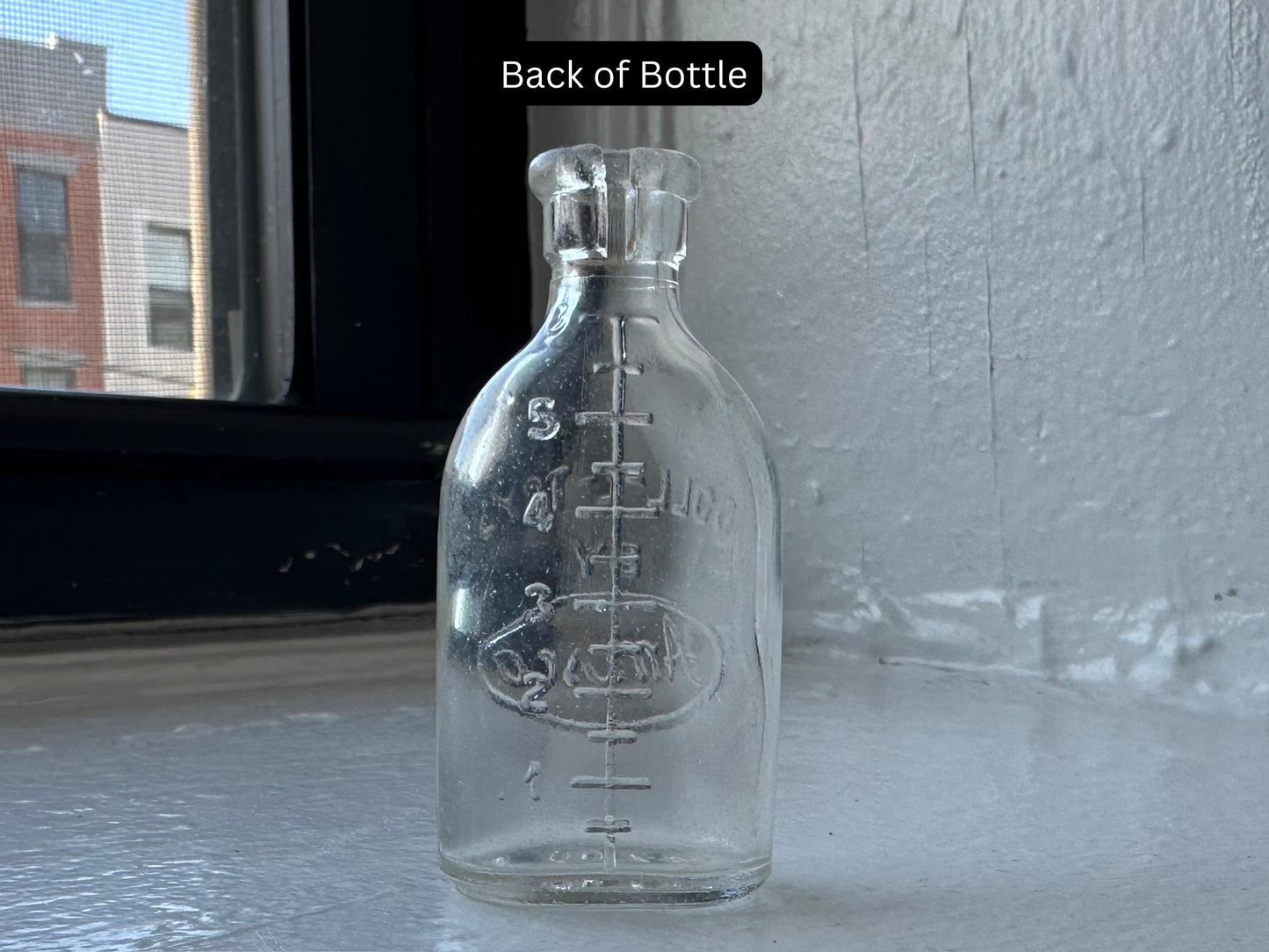 Doll-E-Toys Amsco baby bottle back showing graduated ounce markings, 1950s dollhouse glass collectible