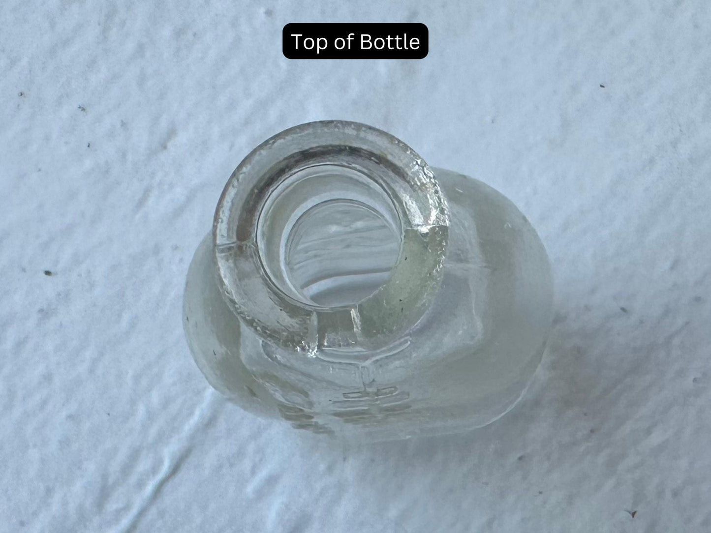 Doll-E-Toys Amsco baby bottle top view showing narrow opening, MCM miniature clear glass collectible