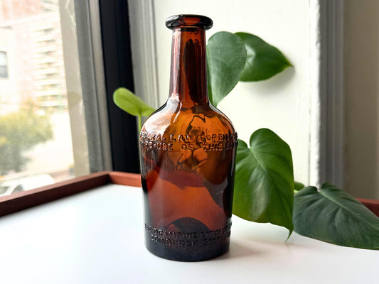 Drambuie amber glass bottle front view, 1940s Federal Law embossing, NYC beach recovery