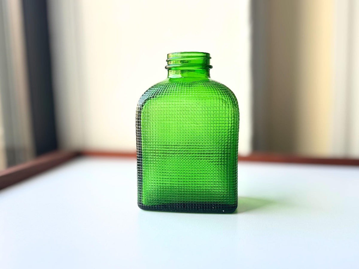 1950 emerald green waffle bottle side view showing rich saturated green color and textured surface detail