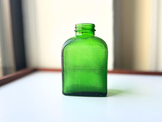 1950 emerald green waffle bottle side view showing rich saturated green color and textured surface detail