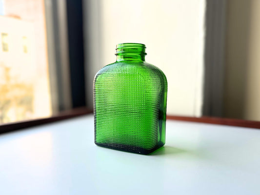 1950 emerald green waffle-grid bottle full front view, raised square texture on flask form, 5.5 inches, NYC recovery