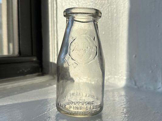 Gimpel Farm milk bottle angled view showing HALF-PINT LIQUID and C STORE markings, 5.25 inch clear glass Queens NY dairy bottle
