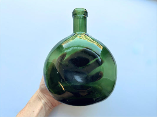 Green onion bottle side view showing rounded shape and forest green glass