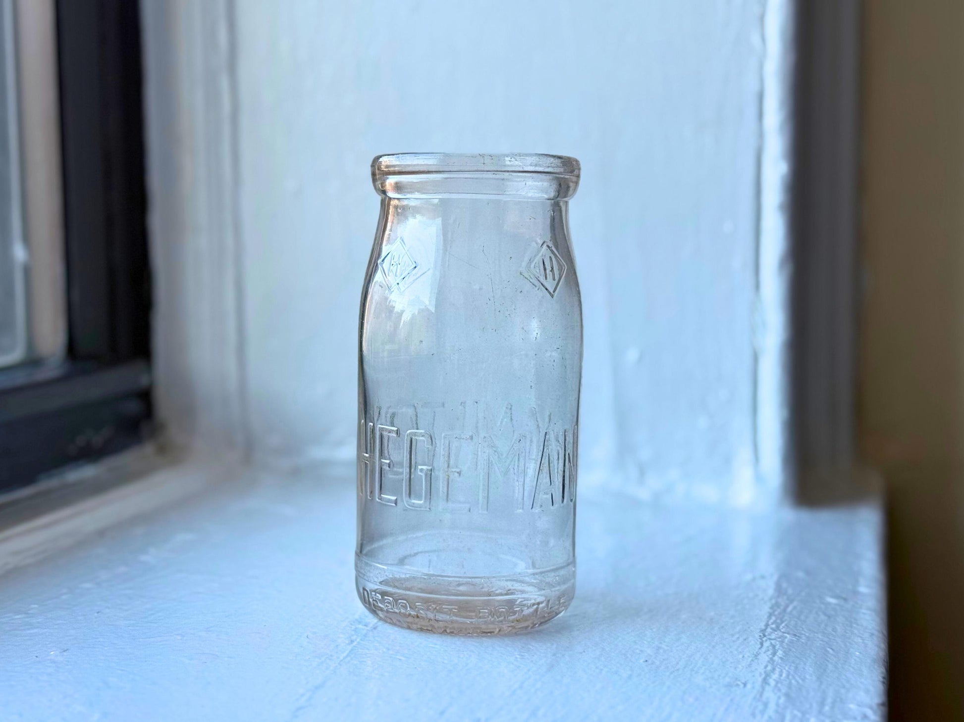 Hegeman Hamilton milk bottle full front view, 1951 Queens NY pint clear glass with diamond H logo