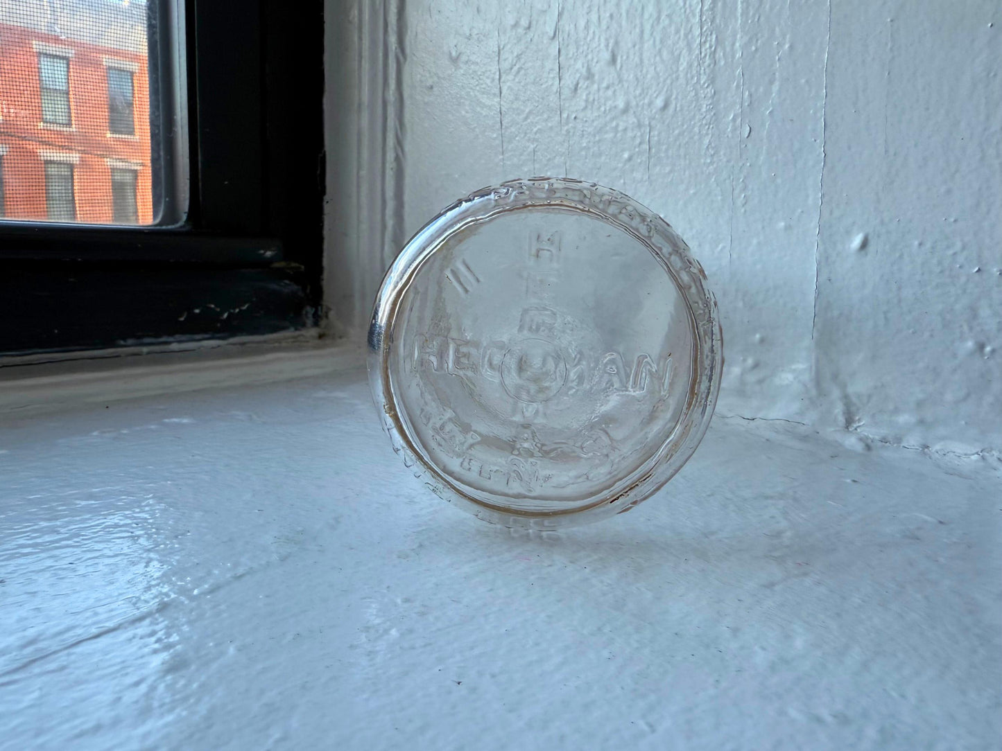 Hegeman Hamilton milk bottle base showing Hegeman embossing and vintage wear, Queens NY dairy history
