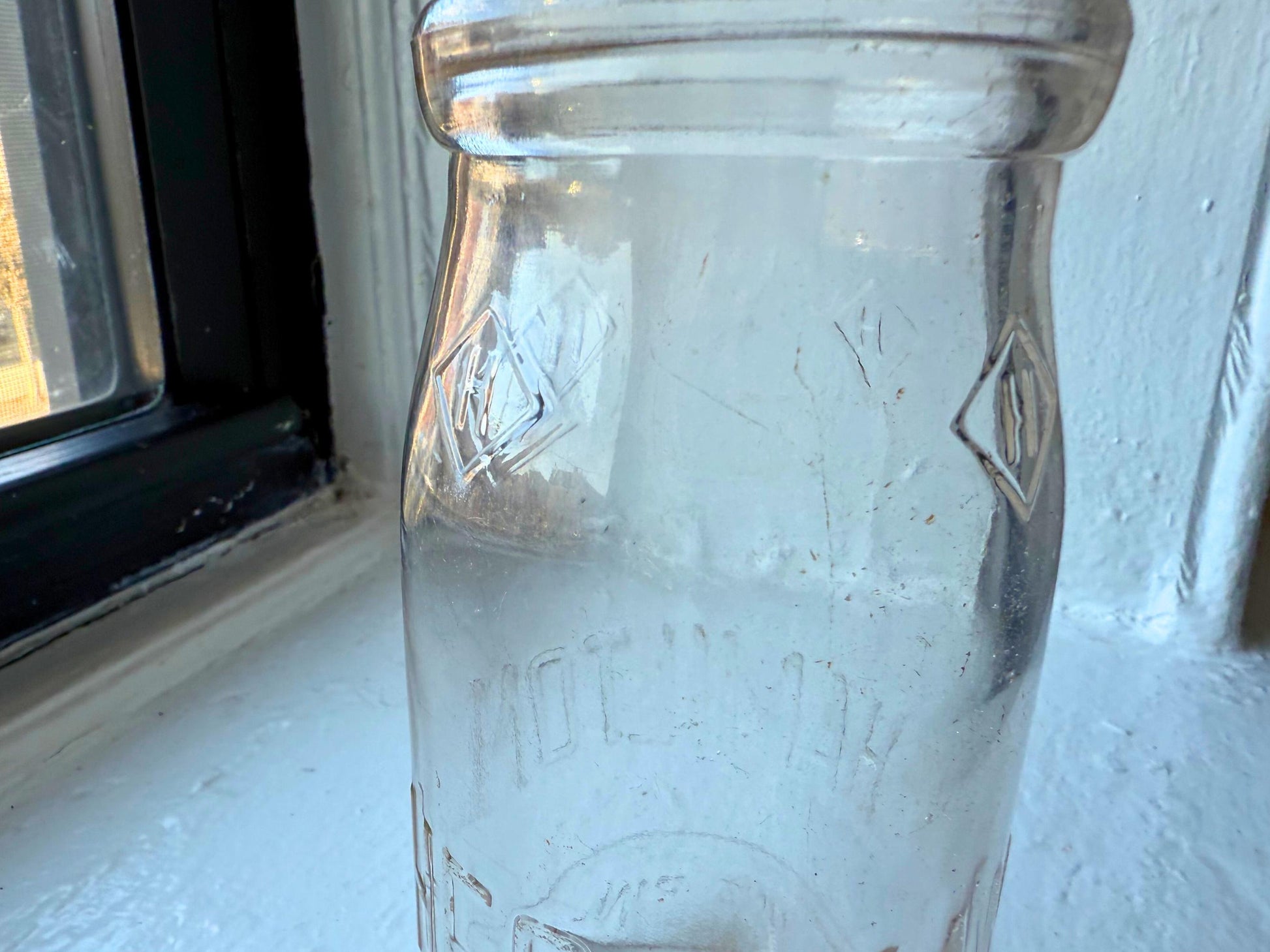 Hegeman Hamilton milk bottle angled view, 1951 pint clear glass Queens NY local dairy collectible