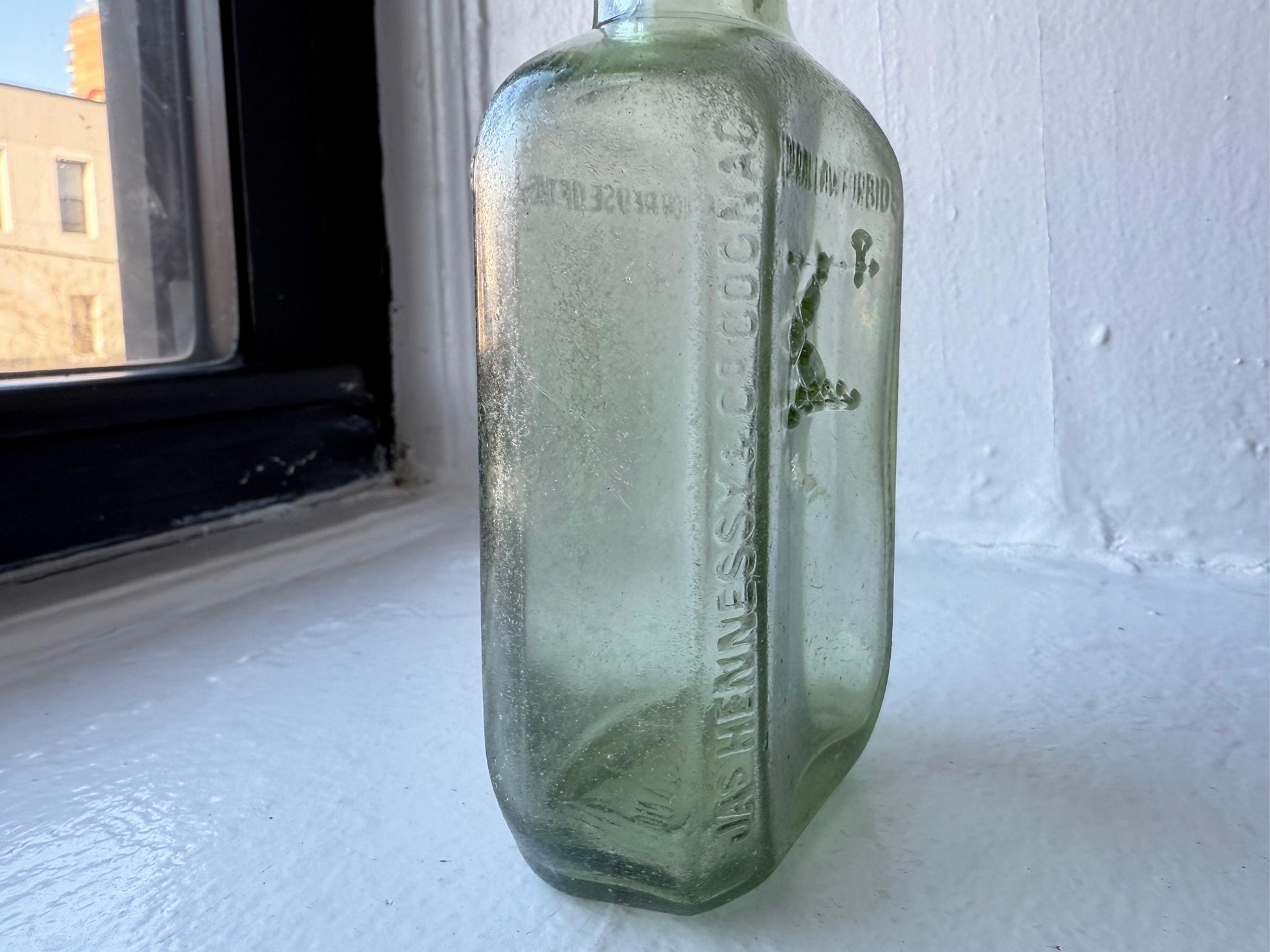 Hennessy 1938 cognac bottle top view showing wide mouth and apple green glass, NYC recovery