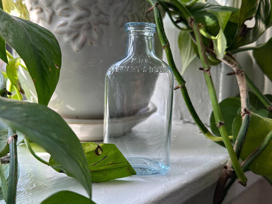 Mrs. Stewart's Bluing was a laundry product used to whiten fabrics. It contained a blue pigment suspended in water. This created a faint blue tint in the wash water, which counteracted the natural yellowing that occurs in white fabrics over time.